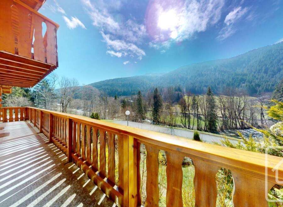 This stunning chalet boasts a spacious balcony with breathtaking mountain views.