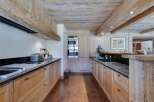 This stunning kitchen boasts a rustic-chic design with exposed wooden beams and a spacious layout.