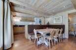 Rustic mountain chalet with exposed wood beams and a cozy dining area.