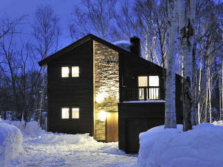 This stunning two-story home boasts a unique stone accent wall, adding a touch of rustic elegance to its modern design.