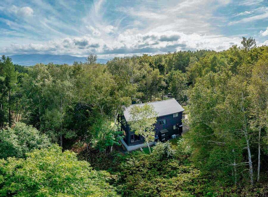 Nestled in a lush forest with mountain views, this secluded home offers a tranquil escape.