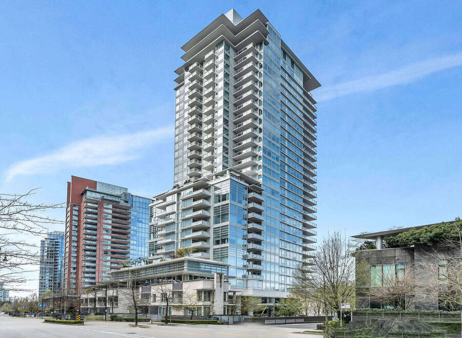 This stunning high-rise building boasts modern architecture with floor-to-ceiling windows offering breathtaking views.