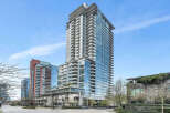This stunning high-rise building boasts modern architecture with floor-to-ceiling windows offering breathtaking views.