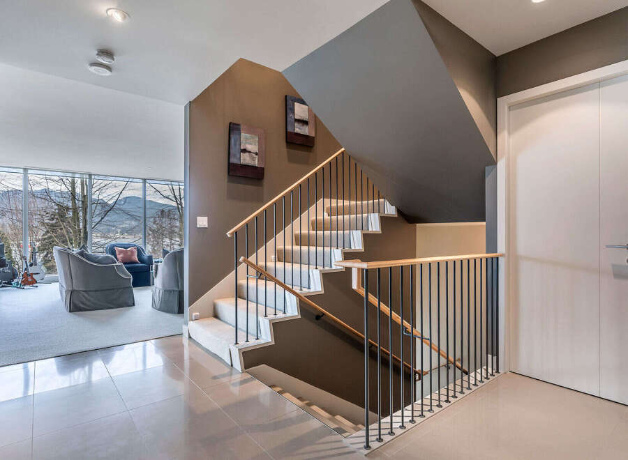 This stunning home boasts a modern, open-concept design with a sleek staircase that is both functional and visually appealing.