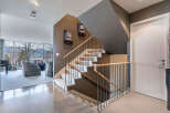 This stunning home boasts a modern, open-concept design with a sleek staircase that is both functional and visually appealing.