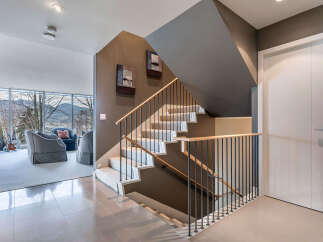 This stunning home boasts a modern, open-concept design with a sleek staircase that is both functional and visually appealing.