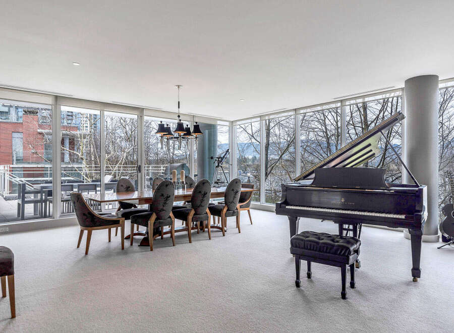 This luxurious condo boasts a spacious open-concept living area with floor-to-ceiling windows offering breathtaking views.