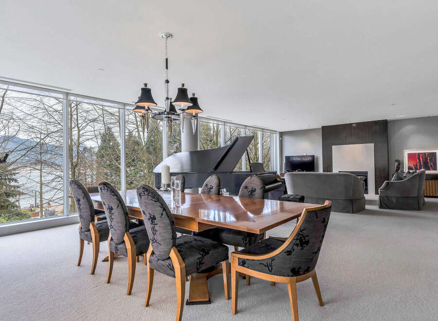 This luxurious home boasts a spacious open-plan living area with floor-to-ceiling windows offering breathtaking views.