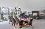 This luxurious home boasts a spacious open-plan living area with floor-to-ceiling windows offering breathtaking views.