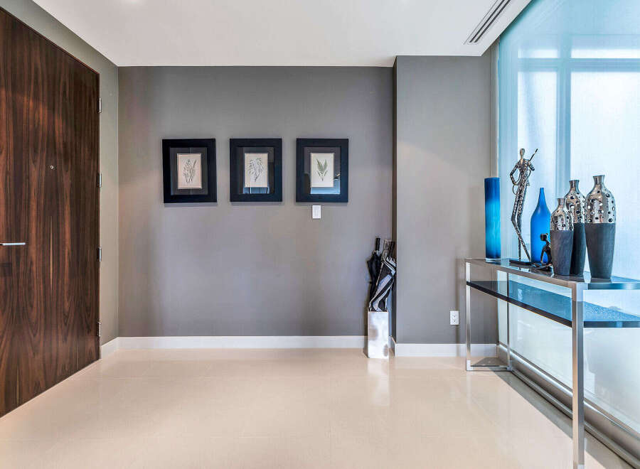 This stunning condo boasts a spacious entryway with sleek, modern design.