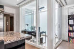 This stunning condo boasts a unique glass-enclosed office space, perfect for working from home while enjoying natural light.
