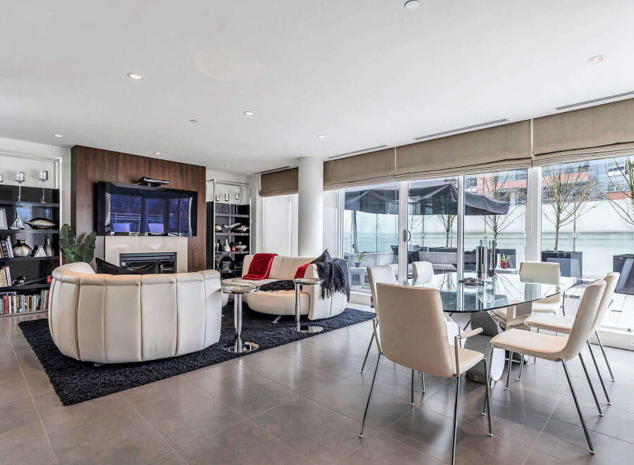This luxurious condo boasts an open-concept living space with floor-to-ceiling windows offering stunning city views.