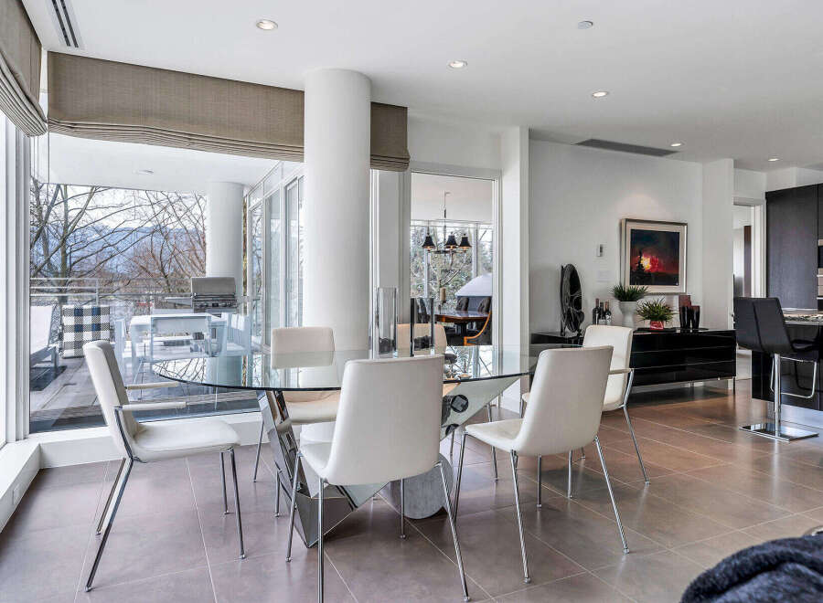 This luxurious condo boasts a spacious open-concept living area with floor-to-ceiling windows offering stunning views.