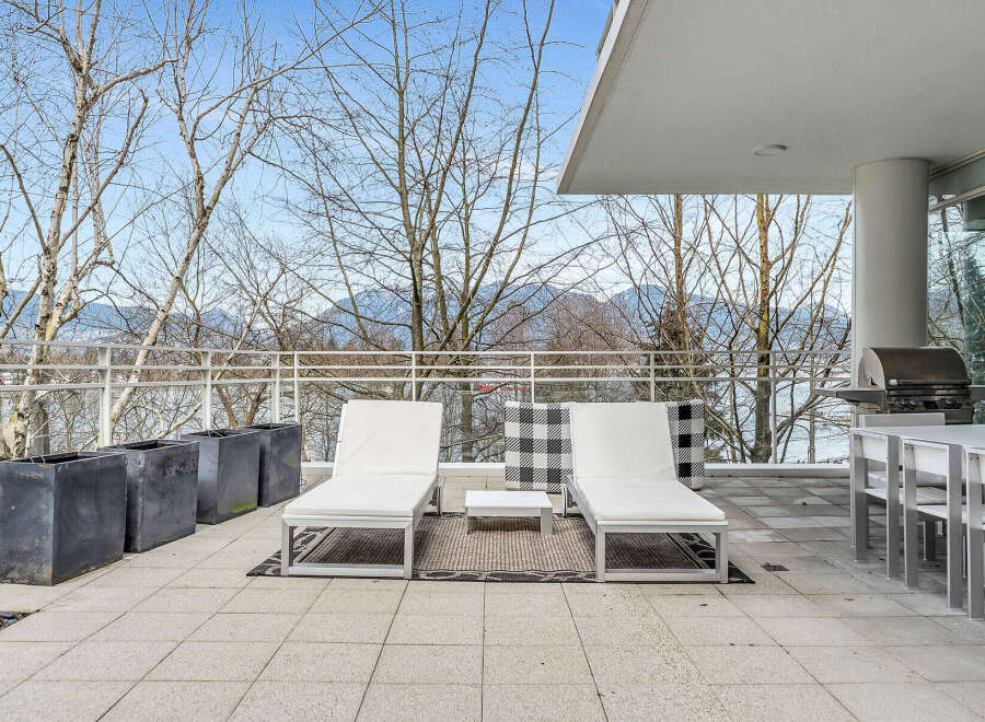 This luxurious condo boasts a spacious balcony with stunning mountain views, perfect for outdoor entertaining.