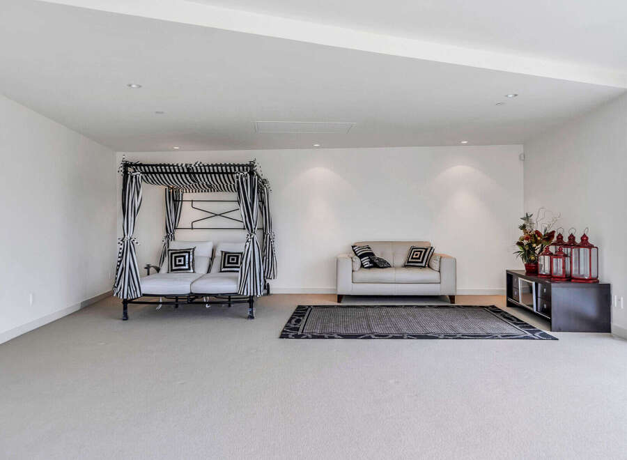 This stunning property boasts a spacious, light-filled living area with plush seating and a unique daybed.