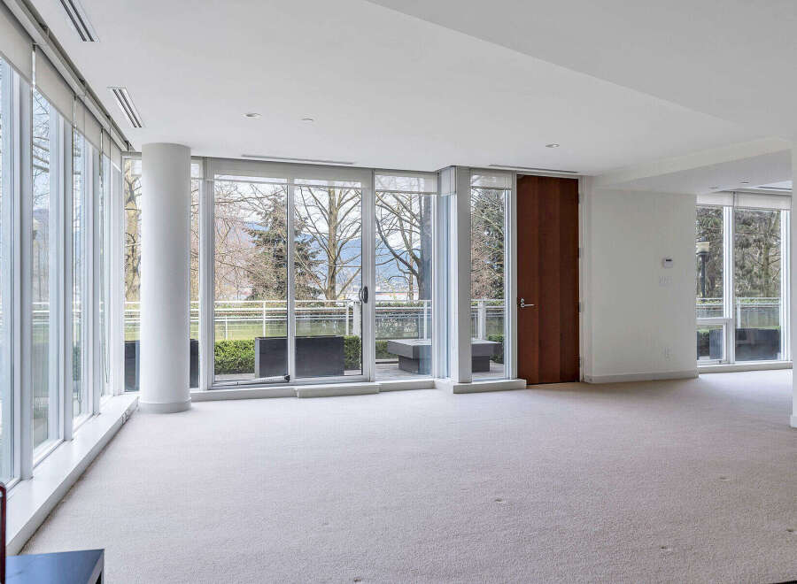 This stunning property boasts expansive windows offering breathtaking views of lush greenery and distant mountains.
