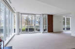 This stunning property boasts expansive windows offering breathtaking views of lush greenery and distant mountains.