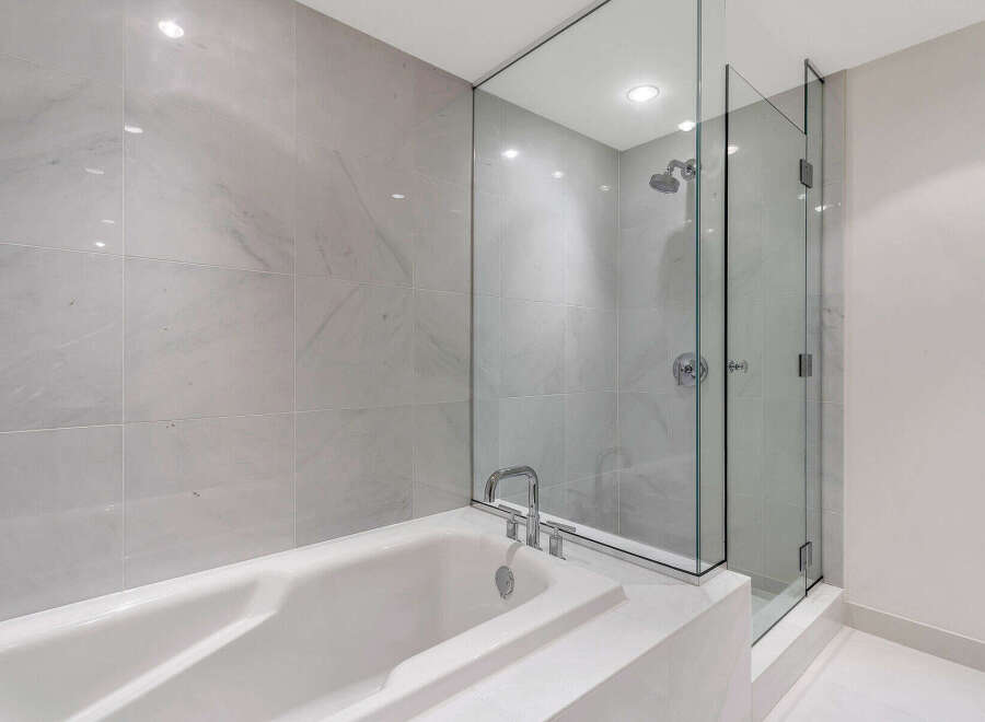 This luxurious bathroom boasts a spacious soaking tub and a separate glass-enclosed shower, perfect for relaxation and rejuvenation.