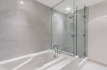 This luxurious bathroom boasts a spacious soaking tub and a separate glass-enclosed shower, perfect for relaxation and rejuvenation.