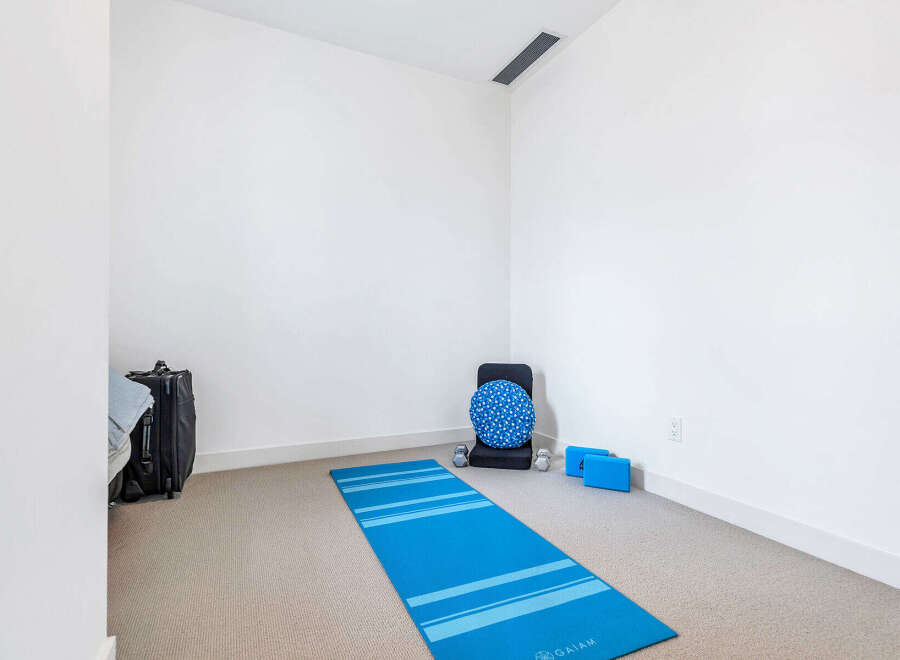This bright and airy room is perfect for yoga and meditation, featuring a dedicated space with a yoga mat, blocks, and bolster.