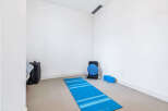 This bright and airy room is perfect for yoga and meditation, featuring a dedicated space with a yoga mat, blocks, and bolster.