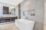 This luxurious bathroom boasts a freestanding soaking tub, perfect for relaxation.