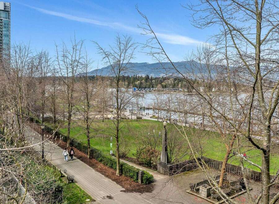 This stunning property boasts breathtaking views of the waterfront and mountains, with a beautifully landscaped park directly across the street.