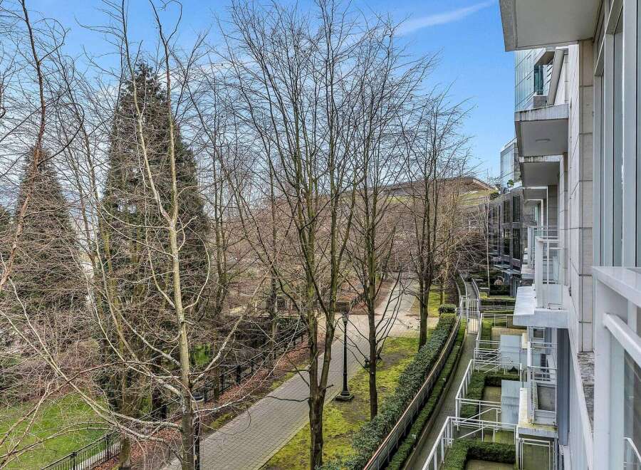 This stunning property boasts a private balcony overlooking a serene, tree-lined walkway, perfect for enjoying morning coffee or evening relaxation.