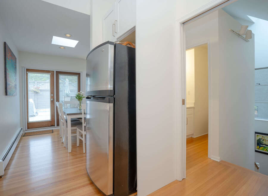 This bright and airy home features hardwood floors throughout, a modern kitchen with stainless steel appliances, and a spacious dining area with access to a private patio.