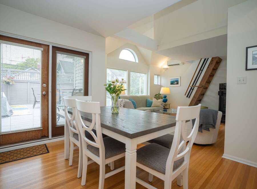This bright and airy condo features an open-concept living and dining area with hardwood floors and large windows.