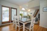 This bright and airy condo features an open-concept living and dining area with hardwood floors and large windows.