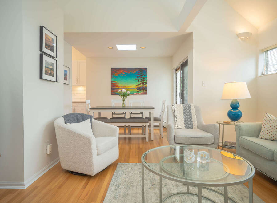 Bright and airy condo with open concept living and dining area.