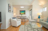 Bright and airy condo with open concept living and dining area.