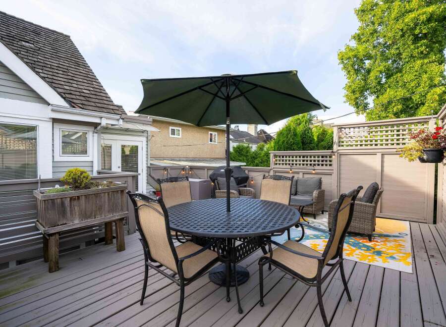 This charming backyard boasts a spacious deck, perfect for outdoor dining and relaxation.