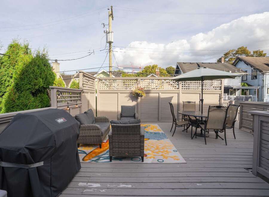 This charming backyard boasts a spacious deck, perfect for outdoor entertaining.