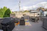 This charming backyard boasts a spacious deck, perfect for outdoor entertaining.