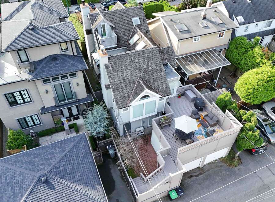 This charming property boasts a spacious rooftop deck perfect for outdoor entertaining, complete with a patio set and umbrella.