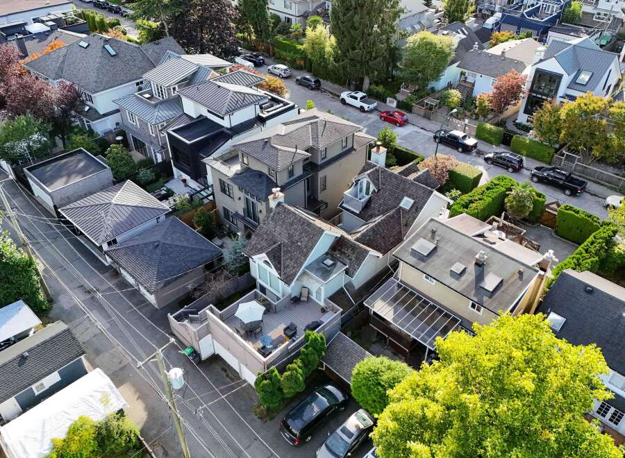 This stunning property boasts a unique architectural design, featuring multiple buildings with varying roof styles and a spacious outdoor patio area.
