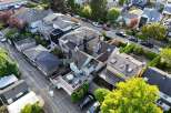 This stunning property boasts a unique architectural design, featuring multiple buildings with varying roof styles and a spacious outdoor patio area.