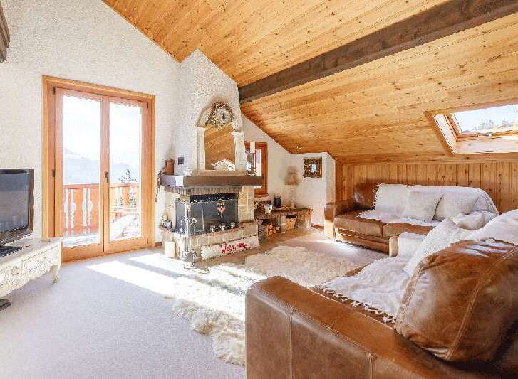 Discover the charm of this cozy living space, featuring a stunning fireplace and a warm, inviting atmosphere.