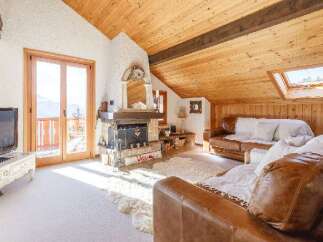 Discover the charm of this cozy living space, featuring a stunning fireplace and a warm, inviting atmosphere.