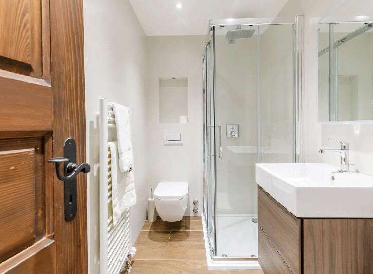 Step into a beautifully designed bathroom featuring a modern shower enclosure and a sleek, contemporary sink.