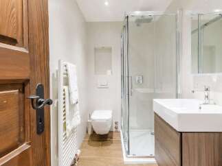 Step into a beautifully designed bathroom featuring a modern shower enclosure and a sleek, contemporary sink.