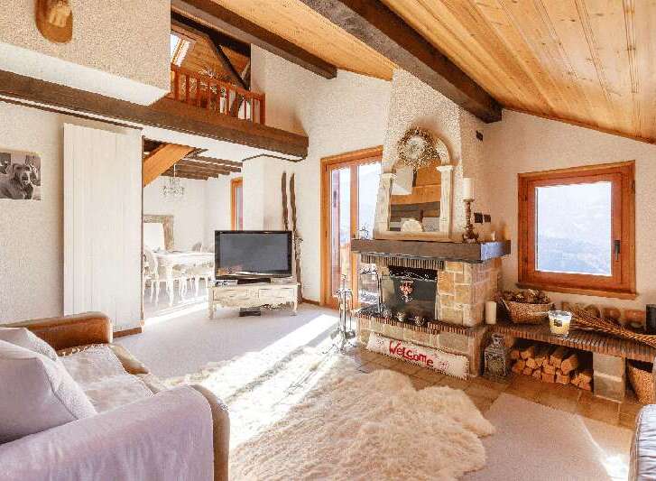 Experience the charm of this cozy chalet, featuring a stunning fireplace and exposed wooden beams.