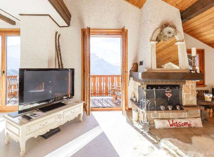 Experience the charm of this cozy chalet, featuring a stunning fireplace and a welcoming "Welcome" mat.