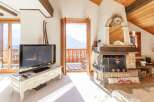 Experience the charm of this cozy chalet, featuring a stunning fireplace and a welcoming "Welcome" mat.
