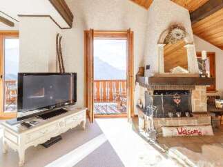 Experience the charm of this cozy chalet, featuring a stunning fireplace and a welcoming "Welcome" mat.
