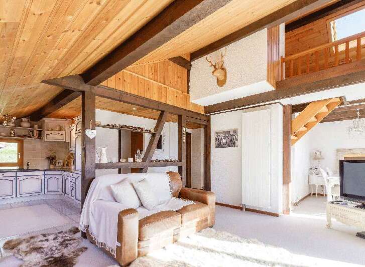 Discover the charm of this rustic home, featuring exposed wooden beams and a cozy living space.