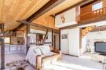 Discover the charm of this rustic home, featuring exposed wooden beams and a cozy living space.