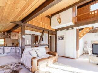 Discover the charm of this rustic home, featuring exposed wooden beams and a cozy living space.